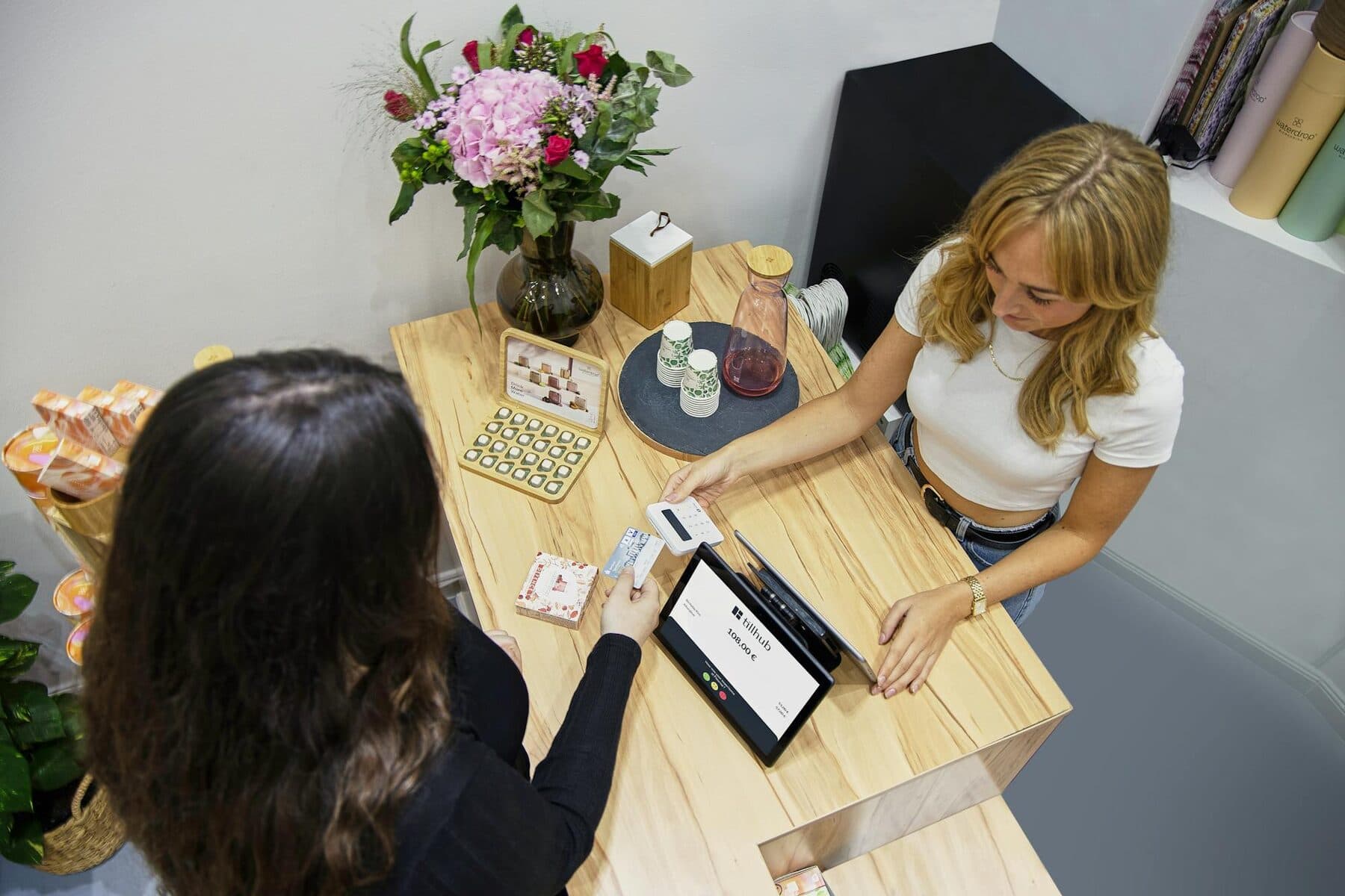 Customer paying at a retail counter